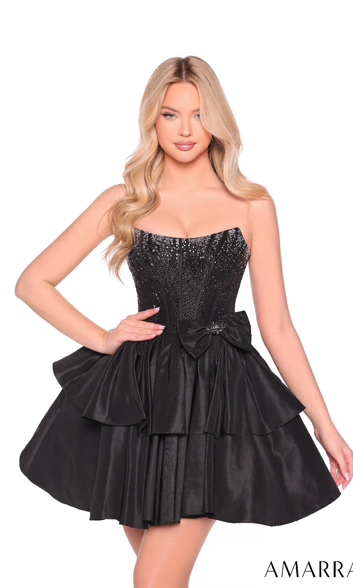 A woman in the Strapless Short Ruffled Hoco Dress: Amarra 88912, featuring a sequined bodice, ruffled skirt, and decorative waist bow, stands against a white background.